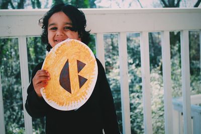 Portrait of happy girl with drawing