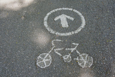 High angle view of arrow sign on road