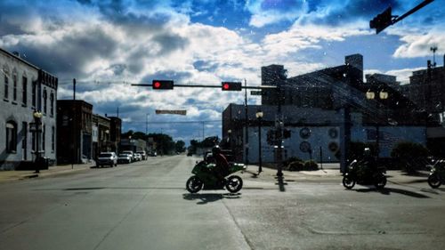 Vehicles on road against buildings