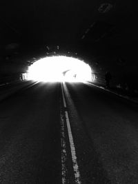 Illuminated tunnel at night