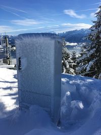 Snow covered landscape against sky