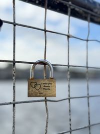 Close-up of padlocks on chainlink fence