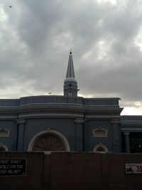 Low angle view of built structure against cloudy sky