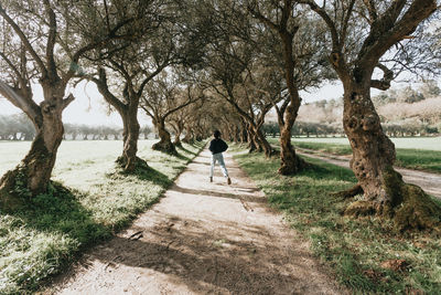 Rear view of man walking on field