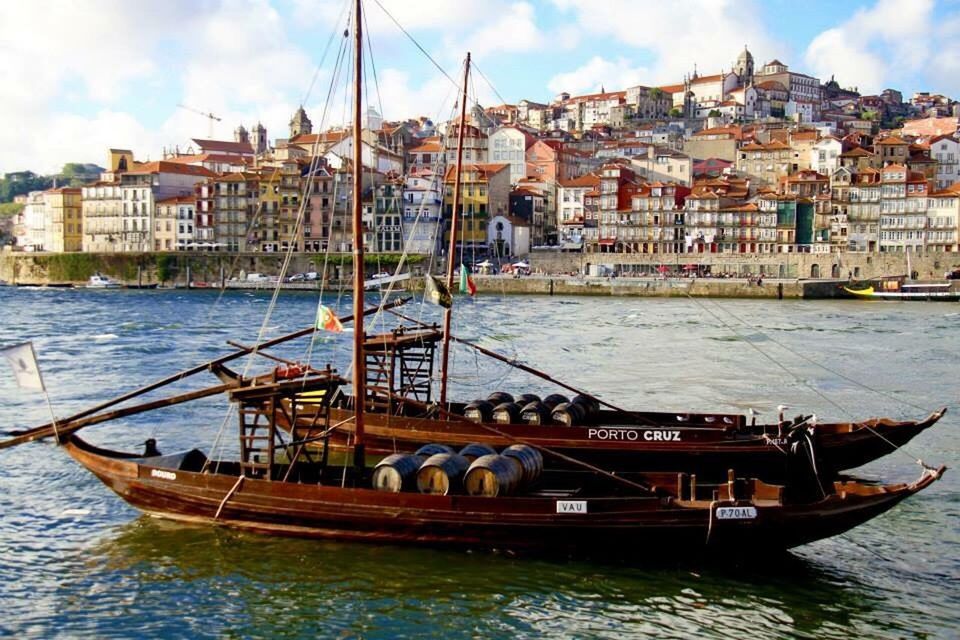 nautical vessel, transportation, mode of transport, city, building exterior, water, sky, architecture, moored, travel destinations, built structure, sea, outdoors, cloud - sky, no people, mast, sailing ship, harbor, day, cityscape, yacht