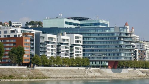 Buildings in city against clear sky