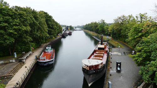 High angle view of bridge over river amidst trees against sky