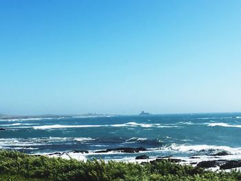 Scenic view of calm sea against clear sky