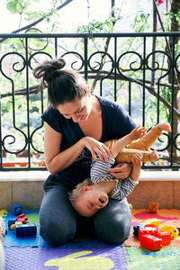 Father and baby boy with toy on floor