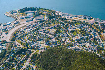 High angle view of trees and buildings by sea