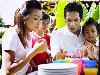 Family celebrating birthday in lawn