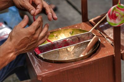 Midsection of man preparing food