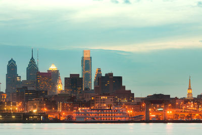 Illuminated buildings in city at dusk