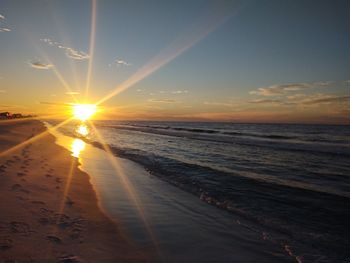 Scenic view of beach against sky during sunset