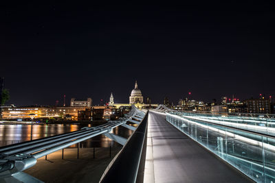 View of illuminated bridge and buildings at night