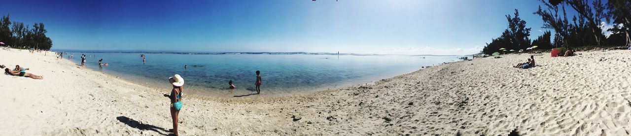 beach, sea, sand, water, shore, horizon over water, blue, sky, tranquility, tranquil scene, scenics, vacations, beauty in nature, panoramic, nature, incidental people, coastline, sunlight, day