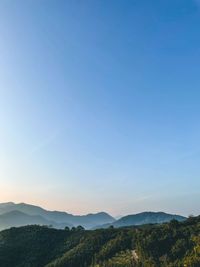 Scenic view of mountains against clear blue sky