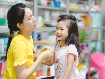 Side view of a girl looking away at store