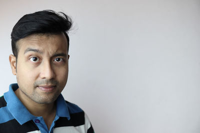 Portrait of young man against white background