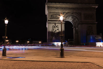 Illuminated light trails on city street at night