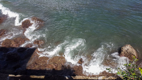 High angle view of rocks in sea