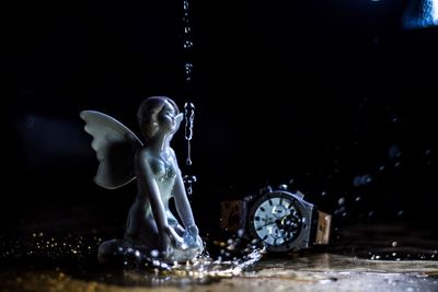 Close-up of water splashing against black background