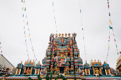 Low angle view of statues against sky