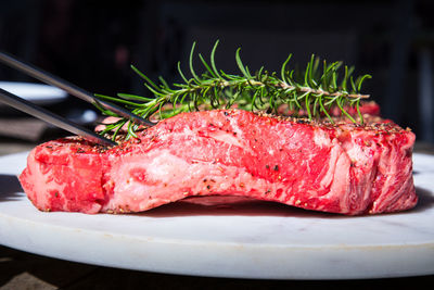 Close-up of raw wagyu ribeye on a  plate on table