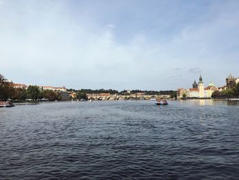 Scenic view of sea by buildings against sky