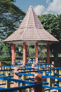 Rear view of people sitting on table against building