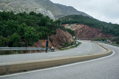 Road by mountain against sky