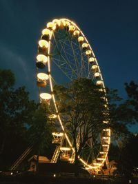 Low angle view of ferris wheel against sky at night