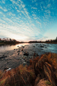 Scenic view of lake against sky during sunset