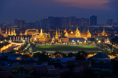 High angle view of illuminated buildings against sky at night