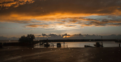 Scenic view of lake against orange sky