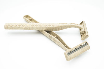 High angle view of razors on white background