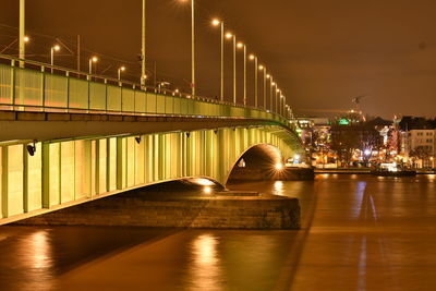 View of bridge over river at night