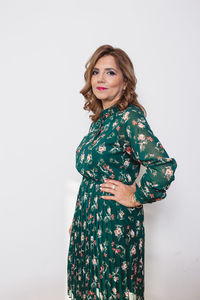 Portrait of woman standing against white background