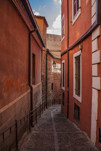 Historical vibrant red buildings in a narrow street in the old town of toledo, spain, europe. 