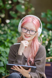 Portrait of young woman sitting on field