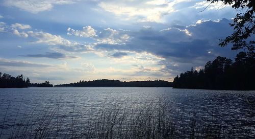 Scenic view of lake against sky at sunset