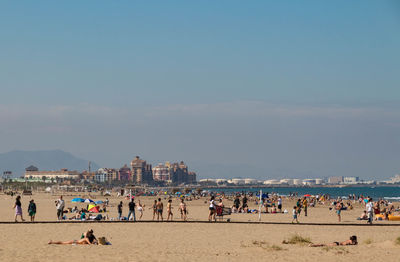 People on beach against sky