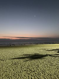 Scenic view of beach against sky during sunset