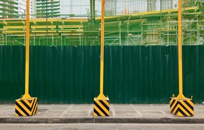 Scaffoldings, safety nets and temporary posts are installed near a construction site in bgc, taguig. 