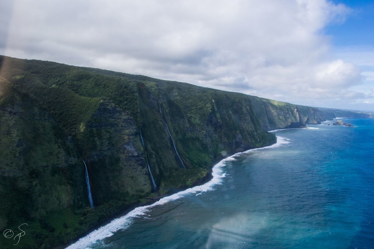 SCENIC VIEW OF WATERFALL AGAINST MOUNTAINS