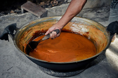 High angle view of person preparing food in container