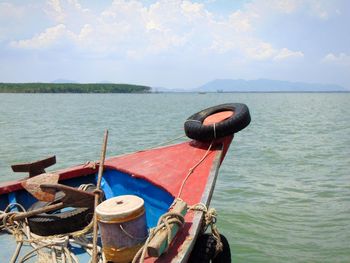 Nautical vessel moored in sea against sky
