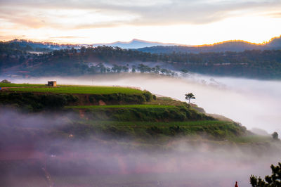 Scenic view of land against sky during sunset