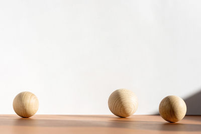 Close-up of balls on table against white background