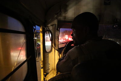 Rear view of man sitting in car